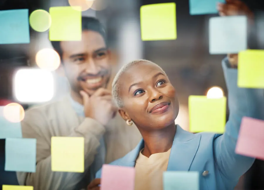 woman looking at sticky notes on wall